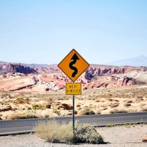 a road sign indicating the road ahead swerves